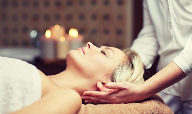 close up of woman having face massage in spa