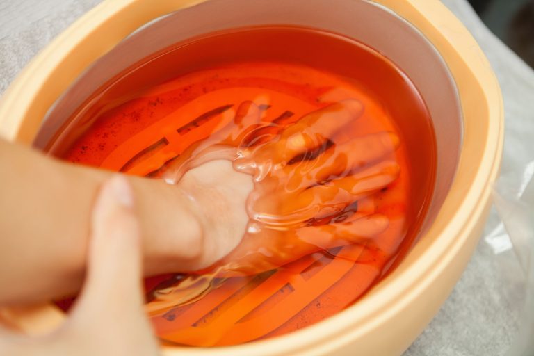 Spa salon. Manicure. Paraffin hand bath