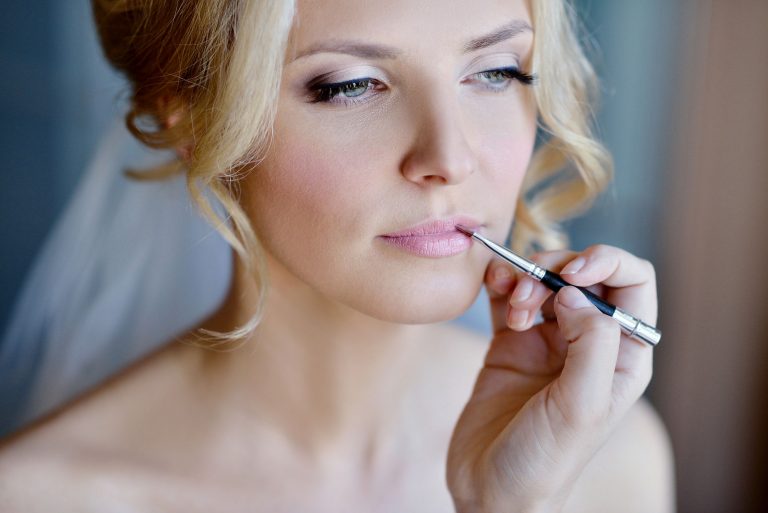 Wedding makeup artist making a make up for bride